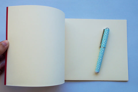 Festive special: notebooks with unique hand-bound decorative designs in red with butterfly binding